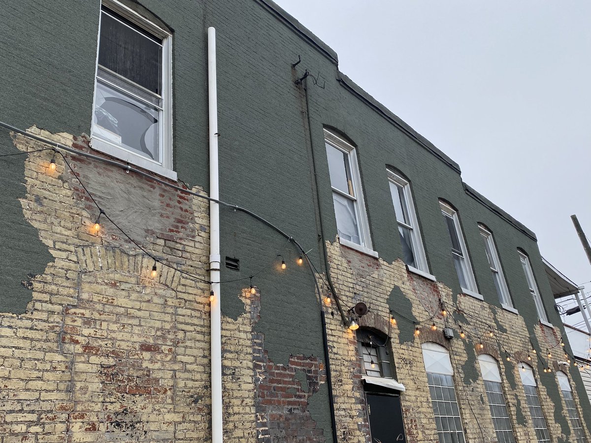 Windows blown out at nearby buildings and shattered glass on the sidewalks from the impact of the powerful coal dust explosion