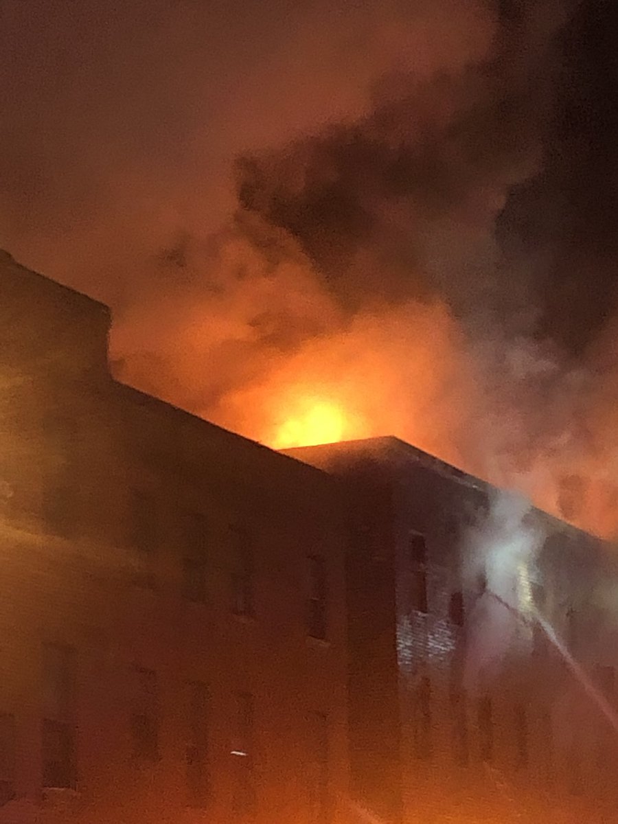 Large fire erupting from the roof of this 4-story building on 22nd St. & Maryland Ave. in Charles North. Firefighters evacuated everyone inside. No injuries to report