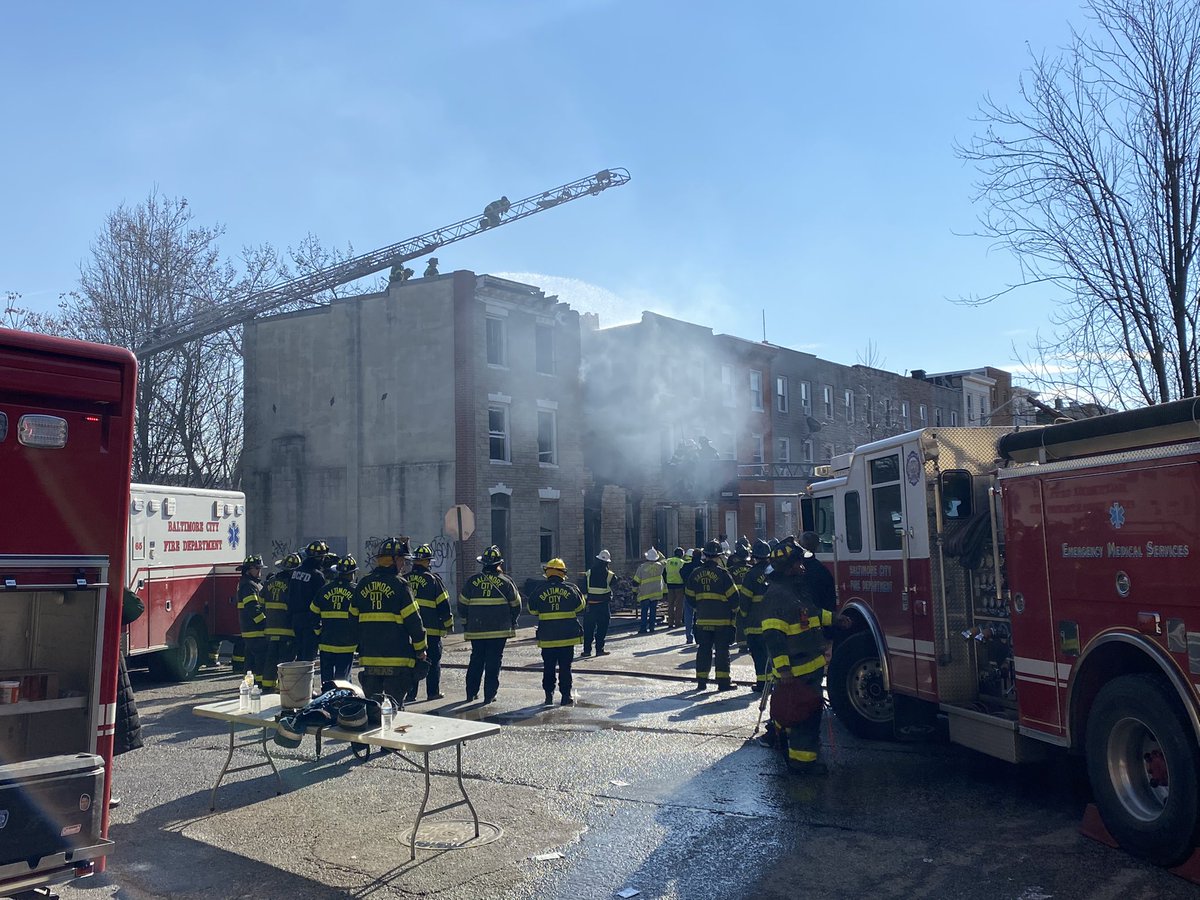 Crews are tearing down the facade of the row home. There's a strong smoke smell as they monitor hot spots.