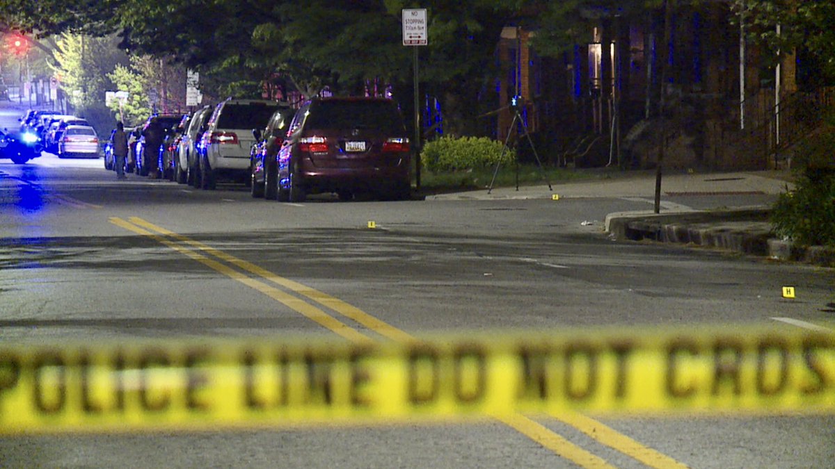 On scene of a reported shooting in East Baltimore. Officers are focused on the area outside a corner store at N Highland and McElderry. There are dozens of evidence markers and people gathered with blankets, hugging one another