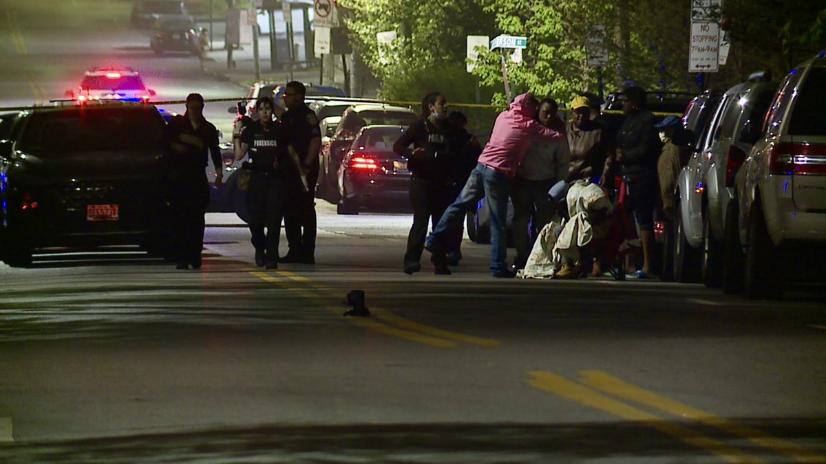 On scene of a reported shooting in East Baltimore. Officers are focused on the area outside a corner store at N Highland and McElderry. There are dozens of evidence markers and people gathered with blankets, hugging one another