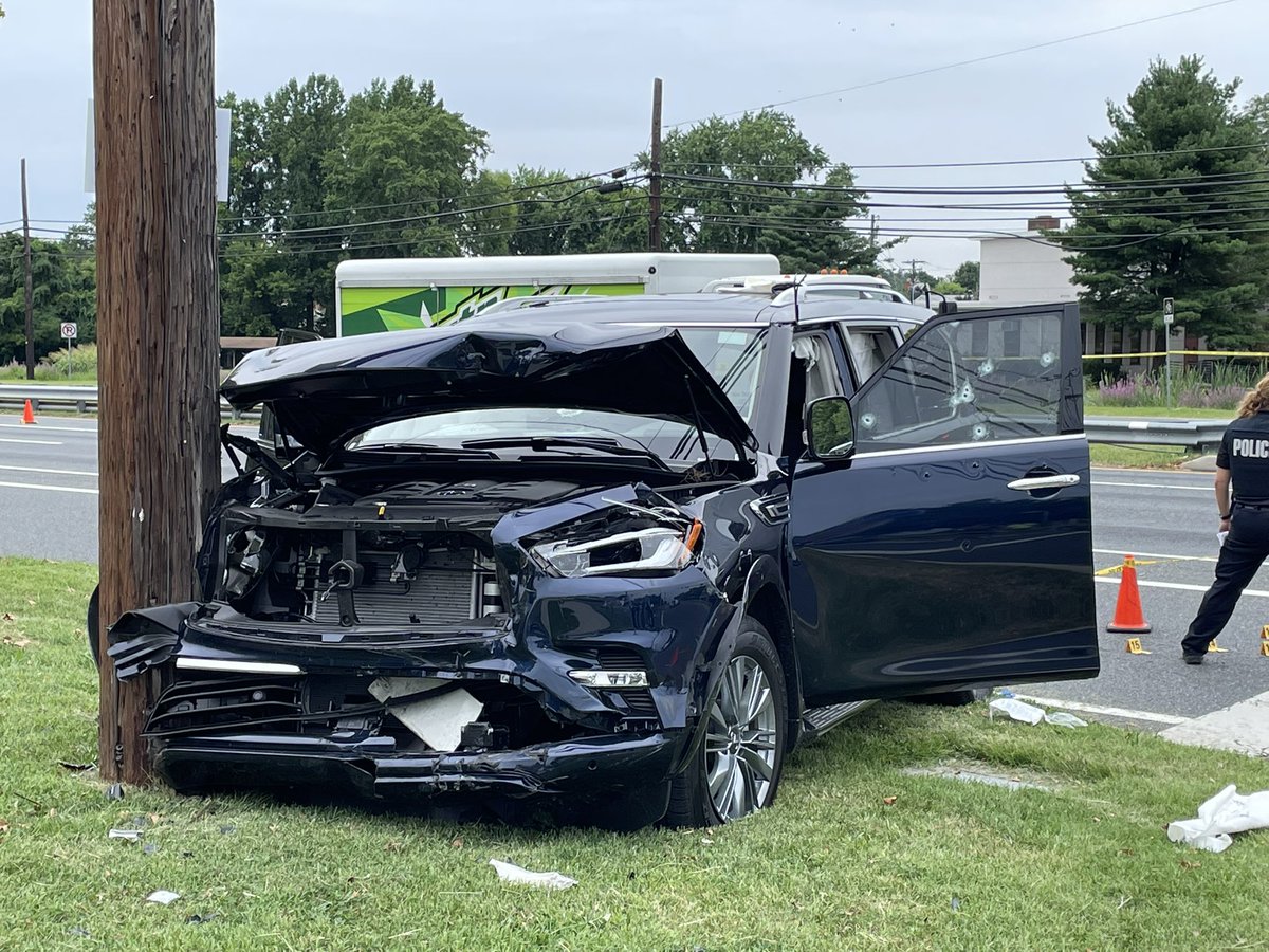 Multiple bullet holes can be seen down the side of this blue SUV. Baltimore County Police say around 10:15am two people were shot at the intersection of Martin Blvd and Compass Rd in Middle River