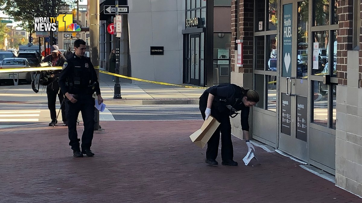 A security officer shot a syringe-wielding theft suspect in the face Friday morning at a store in Harbor East, police said.