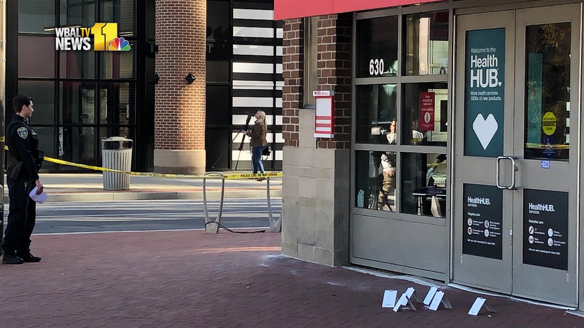 A security officer shot a syringe-wielding theft suspect in the face Friday morning at a store in Harbor East, police said.