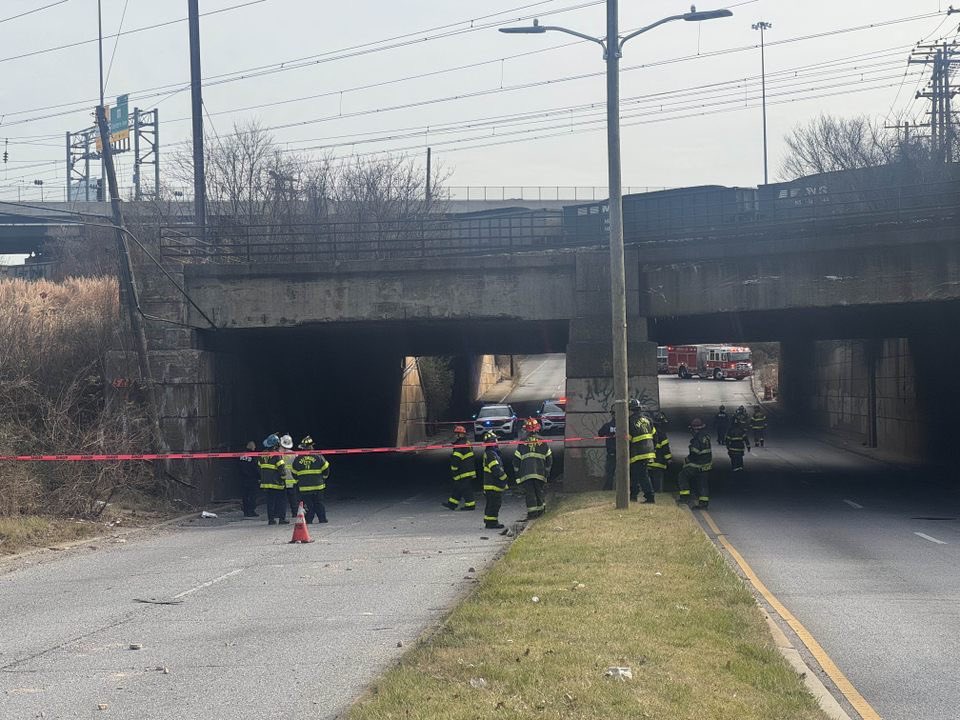 Baltimore  Firefighters are freeing a person trapped in a car after part of a bridge collapsed in Southeast Baltimore.