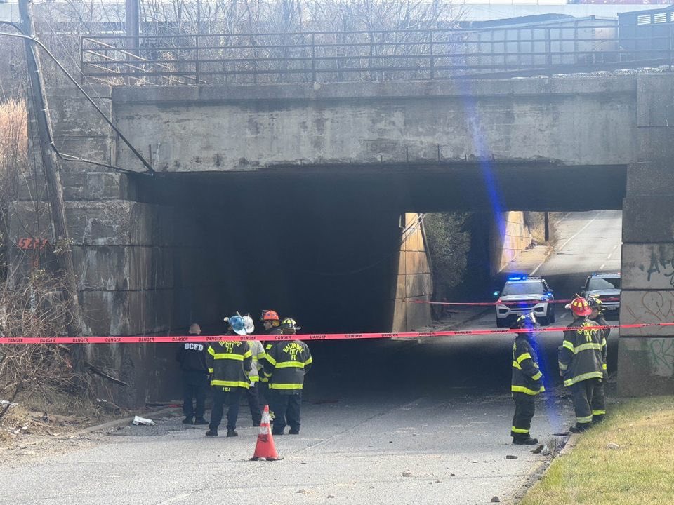 Baltimore  Firefighters are freeing a person trapped in a car after part of a bridge collapsed in Southeast Baltimore. 