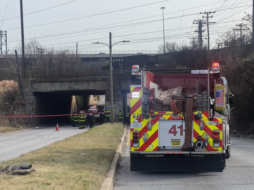 Baltimore  Firefighters are freeing a person trapped in a car after part of a bridge collapsed in Southeast Baltimore. 