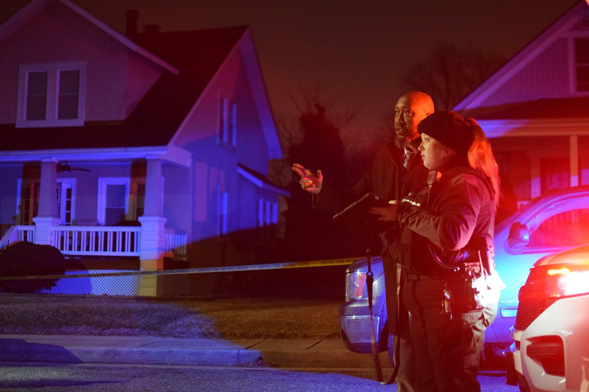 Homicide detective Frank Jenkins discusses with a crime lab technician the parameters of a crime scene in the 4400 block of Marx Avenue. Jenkins was one of the detectives sent to the location after a young man was fatally shot on Monday