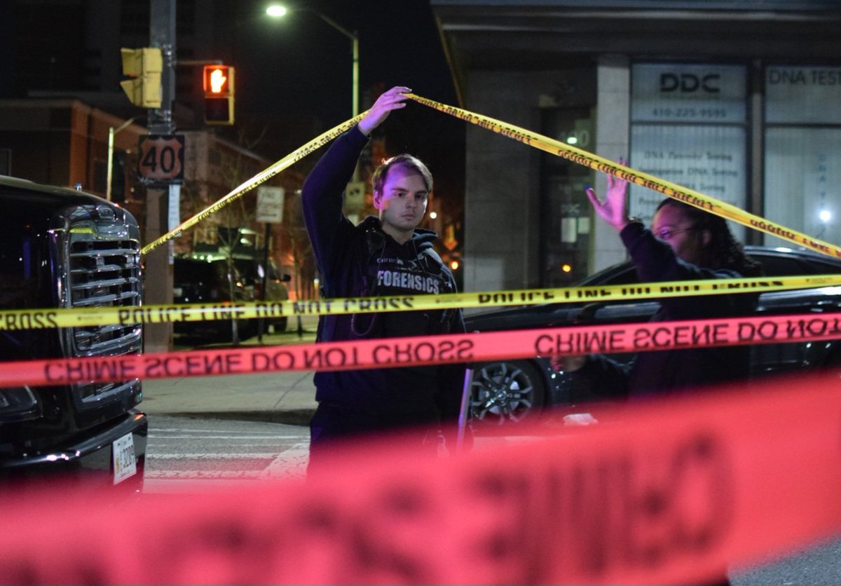Crime lab technicians enter a block of downtown Baltimore where an officer shot a man during a traffic stop gone wrong. The shooting happened in the 300 block of West Franklin Street around 9:20 p.m. on Wednesday. Police say the officer was dragged by the car he had stopped