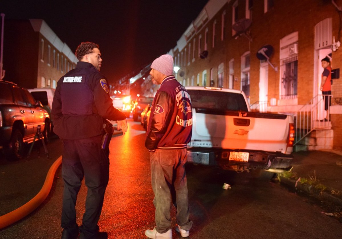 Police shut down the 400 block of North Curley Street so that fire inspectors and crime lab technicians could investigate a fire that injured two people on Friday night