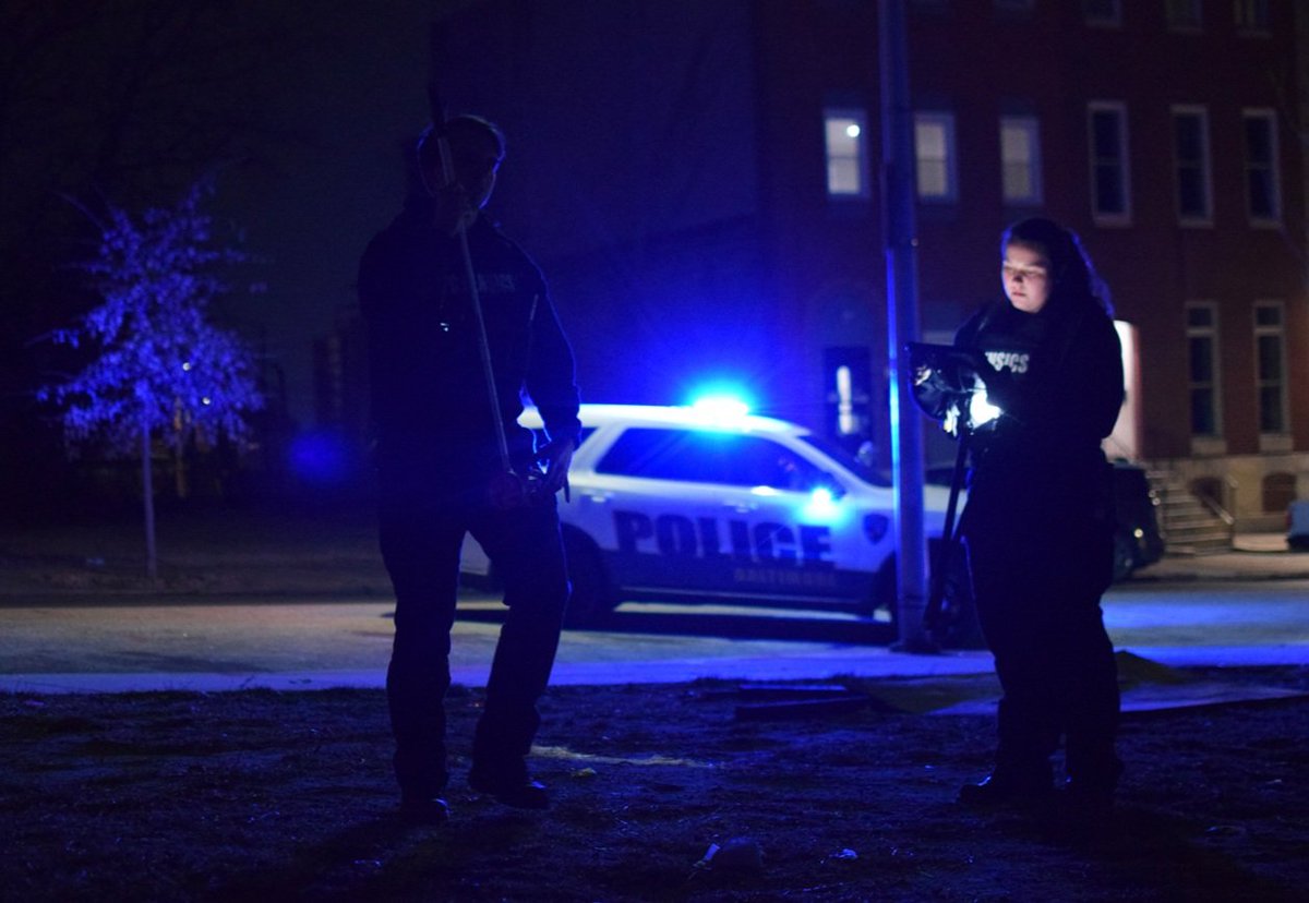Crime lab technicians collect evidence of a shooting that injured a 31-year-old man near the 800 block of North Fremont Avenue