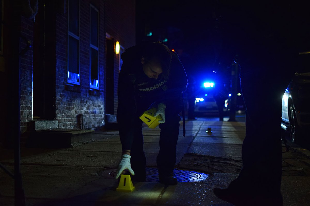 The center of the crime scene was in the 800 block of West Lexington Street. Evidence of the gunfire snaked through an alleyway next the corner store and ended with casings on the other side of Poppleton Place Apartments