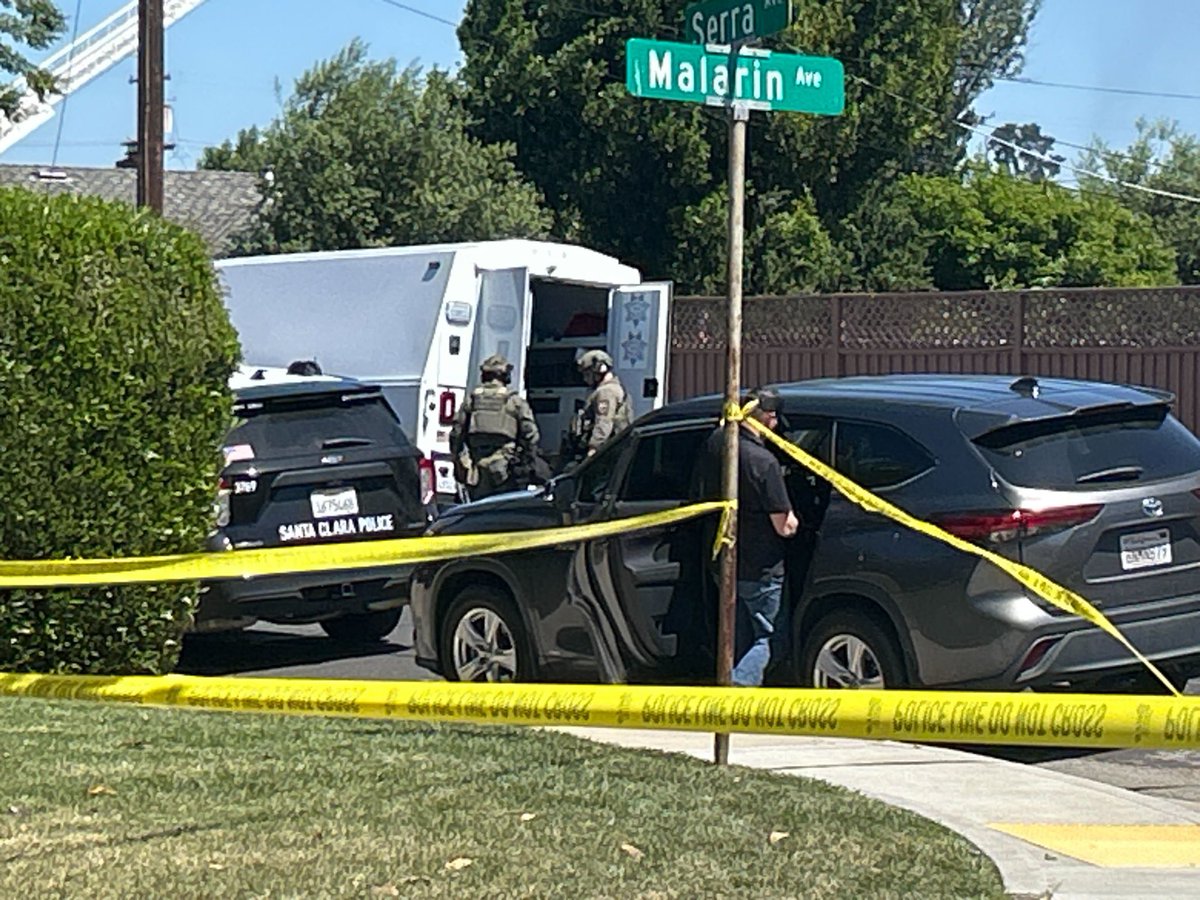Investigation ongoing after victim shot & killed on Enright & nearby home erupts into flames, drawing SWAT teams & armored vehicles to neighborhood 