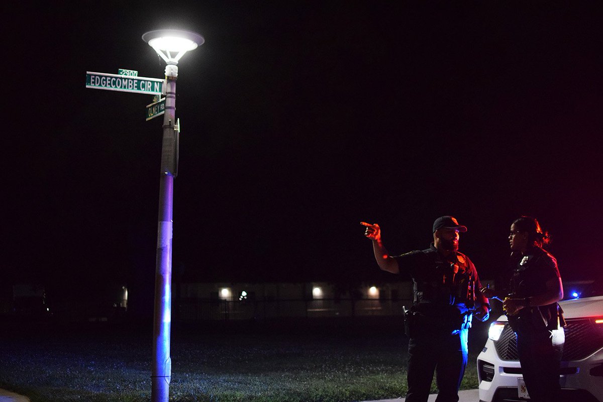An officer points at a crime scene in the 2900 block of Edgecombe Circle North. That's where a 47-year-old man was shot around 10 p.m. on Friday, according to authorities
