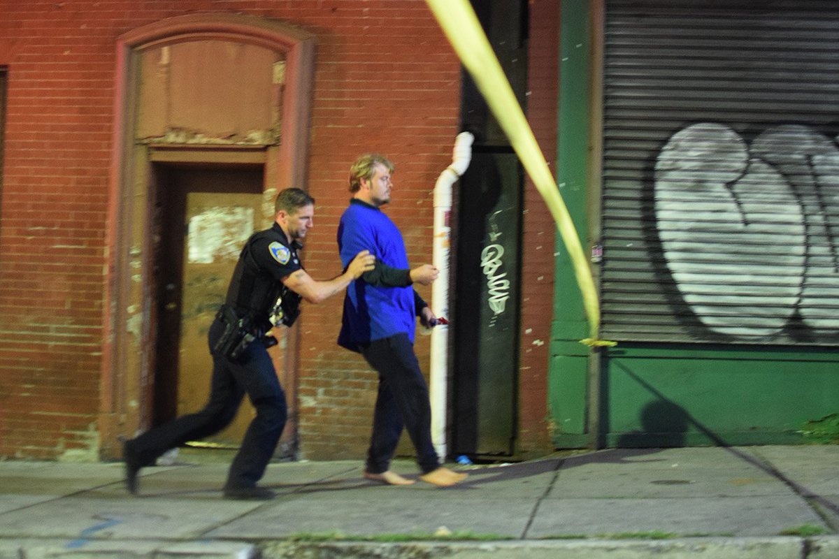 One man had to be escorted out of the crime scene. But also, it was the same man who announced in response to the presence of officers that he didn't care because